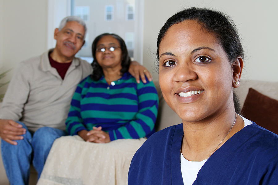 A senior home care worker smiles before her comforted clients